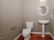 Elegant half-bathroom features a pedestal sink, round mirror, and neutral wall color at 400 Leacroft Way, Morrisville, NC 27560