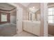 Bathroom sink with white cabinets and large mirror with a view of the bedroom at 400 Leacroft Way, Morrisville, NC 27560