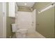 Green walled bathroom with toilet, and shower-tub combination with white tile at 400 Leacroft Way, Morrisville, NC 27560