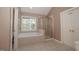 Bathroom featuring tiled floors, soaking tub, glass enclosed shower, and natural light from the window at 400 Leacroft Way, Morrisville, NC 27560