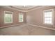 Neutral bedroom with tray ceiling, fan, and multiple windows allowing lots of natural light at 400 Leacroft Way, Morrisville, NC 27560