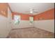 bedroom with tan carpet, white wainscotting and orange wall paint at 400 Leacroft Way, Morrisville, NC 27560
