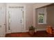Welcoming foyer with white trim and hardwood floors, showcasing natural light from side windows at 400 Leacroft Way, Morrisville, NC 27560