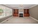Cozy living room features a fireplace, built-in shelving, and large windows for natural light at 400 Leacroft Way, Morrisville, NC 27560