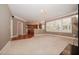 Open-concept living area leading to the kitchen with large windows and ample lighting at 400 Leacroft Way, Morrisville, NC 27560