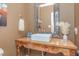 Charming powder room featuring a mosaic mirror, wooden vanity, and vessel sink at 442 Hunters Pointe Rd, Nashville, NC 27856