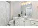 Well-lit bathroom boasting a modern vanity with a vessel sink and a shower with a decorative curtain at 442 Hunters Pointe Rd, Nashville, NC 27856
