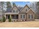 Beautiful two-story home with a covered front porch, manicured landscaping, and mixed siding at 442 Hunters Pointe Rd, Nashville, NC 27856
