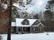 Two-story home blanketed in snow features mixed siding and a covered front porch at 442 Hunters Pointe Rd, Nashville, NC 27856