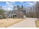 Two-story home with a stone facade, covered porch, and long private driveway at 442 Hunters Pointe Rd, Nashville, NC 27856
