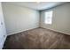 Neutral bedroom with plush carpeting, a window providing natural light, and ample space for furniture at 5014 Kota St, Raleigh, NC 27610
