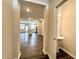 Inviting entryway showcases pristine hardwood floors and an open floor plan with a view of the kitchen and living area at 5014 Kota St, Raleigh, NC 27610