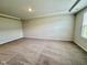 Spacious living room featuring neutral paint, plush carpet, and ample natural light at 5014 Kota St, Raleigh, NC 27610