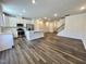 Spacious living room showcases a modern kitchen with stainless steel appliances and an open-concept design at 5014 Kota St, Raleigh, NC 27610