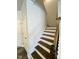 Elegant staircase features wood steps, white risers, and an iron railing, leading to the upper level at 5014 Kota St, Raleigh, NC 27610