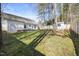Spacious backyard featuring lush grass, a patio with seating, a storage shed, and a wooden fence for privacy at 513 Jaffiley Ct, Wake Forest, NC 27587