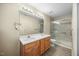 Bright bathroom featuring a double vanity and a glass-enclosed shower, offering a clean and functional space at 513 Jaffiley Ct, Wake Forest, NC 27587