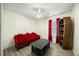 Eclectic bedroom featuring a unique bookcase and red couch at 513 Jaffiley Ct, Wake Forest, NC 27587