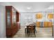 Bright open concept dining room featuring wood floors, a classic china cabinet, and a modern kitchen at 513 Jaffiley Ct, Wake Forest, NC 27587