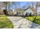 Long driveway leading to a charming single-story home with a welcoming front porch at 513 Jaffiley Ct, Wake Forest, NC 27587