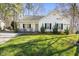 Charming single-story home with a welcoming front porch, lush lawn, and mature trees at 513 Jaffiley Ct, Wake Forest, NC 27587