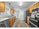 Modern kitchen boasts stainless steel appliances, wood cabinets, and wood floors, combining style with convenience at 513 Jaffiley Ct, Wake Forest, NC 27587