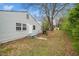 Back exterior of home with well maintained lawn and outbuilding at 513 Kenway St, Garner, NC 27529