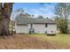 Exterior view of the back of the home from the yard showing a large yard and light gray siding at 513 Kenway St, Garner, NC 27529