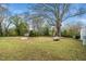 Spacious backyard with mature trees, a shed, and plenty of open space for outdoor activities at 513 Kenway St, Garner, NC 27529
