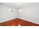 Bedroom featuring hardwood floors, white walls, and two windows at 513 Kenway St, Garner, NC 27529