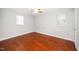 Bedroom featuring hardwood floors, white walls, and two windows at 513 Kenway St, Garner, NC 27529