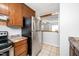 Galley kitchen featuring stainless steel refrigerator and breakfast bar access at 513 Kenway St, Garner, NC 27529