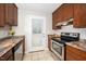 Well-lit kitchen featuring stainless steel appliances and wood cabinets at 513 Kenway St, Garner, NC 27529