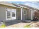 Exterior view of a home featuring a private patio with sliding glass doors and a storage area at 60 Justin Ct, Durham, NC 27705