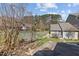 Exterior view shows the side of the property with a stream running through the backyard at 60 Justin Ct, Durham, NC 27705