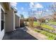 Side patio featuring a small patch of grass and partial view of surrounding homes at 60 Justin Ct, Durham, NC 27705