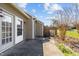 Outdoor patio area featuring sliding glass doors, a utility door, and an A/C unit at 60 Justin Ct, Durham, NC 27705