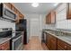 Kitchen with stainless appliances, granite counters, and stylish backsplash at 60 Justin Ct, Durham, NC 27705