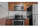 Modern kitchen featuring stainless steel appliances and granite countertops at 60 Justin Ct, Durham, NC 27705