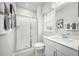 Bright bathroom with a glass shower, granite countertop, and light gray tile flooring at 603 Silverado Sunset Loop, Wendell, NC 27591