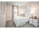 Charming bedroom with light pink walls, soft carpet, cozy bedding, and coordinated decor at 603 Silverado Sunset Loop, Wendell, NC 27591