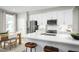 Modern kitchen with white cabinets, stainless steel appliances, quartz countertops and a large island with seating at 603 Silverado Sunset Loop, Wendell, NC 27591