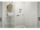 A clean, well-organized laundry room featuring storage shelves and tiled floors at 603 Silverado Sunset Loop, Wendell, NC 27591