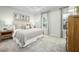 Calm main bedroom featuring neutral decor, tray ceiling, carpeted floors, and large windows for natural light at 603 Silverado Sunset Loop, Wendell, NC 27591