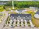 Aerial view of the community, showcasing the layout, water tower, and proximity to nearby wooded areas at 605 Silverado Sunset Loop, Wendell, NC 27591