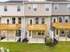Townhome exteriors boast rear patios and decks overlooking private backyard spaces at 605 Silverado Sunset Loop, Wendell, NC 27591