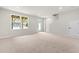 Unfinished basement with a window, a white door, and carpeted floor at 605 Silverado Sunset Loop, Wendell, NC 27591