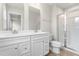 Modern bathroom with double vanity, bright mirrors, and glass enclosed shower at 605 Silverado Sunset Loop, Wendell, NC 27591