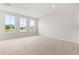 Bright bedroom featuring three windows providing natural light, carpeted floor, and neutral walls at 605 Silverado Sunset Loop, Wendell, NC 27591