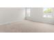 Bright bedroom featuring two windows providing natural light, carpeted floor, and neutral walls at 605 Silverado Sunset Loop, Wendell, NC 27591